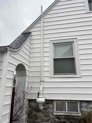 Radon Mitigation System Installed in Fieldstone Home in Waterbury (Exterior)