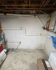 Two-Pipe Radon Mitigation System Installed in Guilford Split-Level Home (Basement Foundation Area)