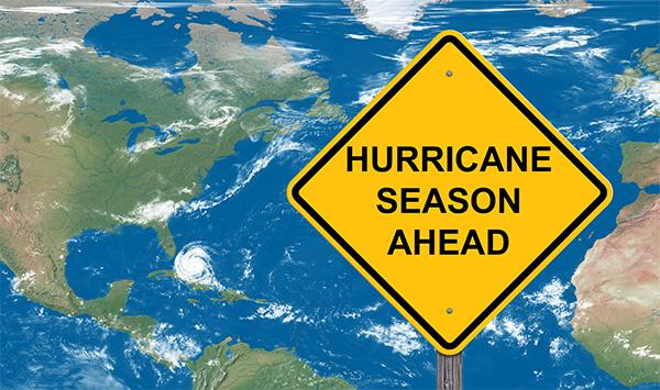 The graphic shows a Hurricane Season caution sign.