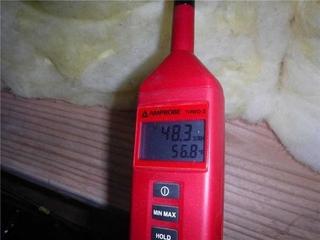 The picture shows a humidity monitor being used in a crawlspace.