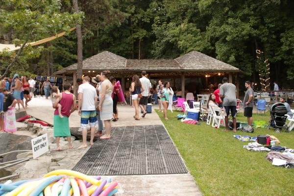 The picture shows employees and their loved ones enjoying the company picnic.