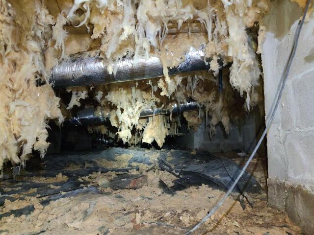 Insulation falling from the floorboards.