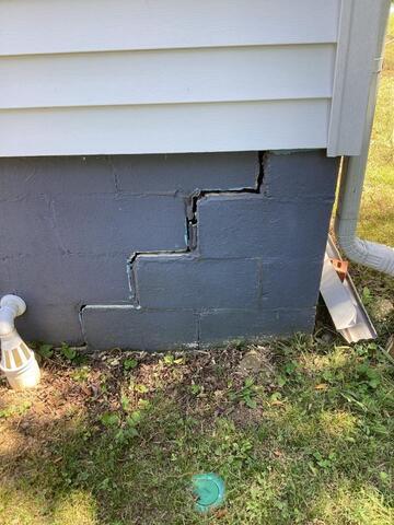 Stair-stepping cracks in an exterior brick wall.