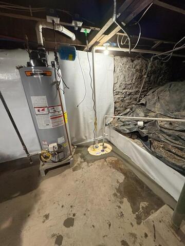 A sump pump and waterguard system in a basement. 