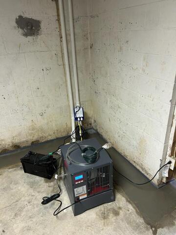 SaniDry Sedona Dehumidifier in the basement near the TripleSafe Sump Pump.