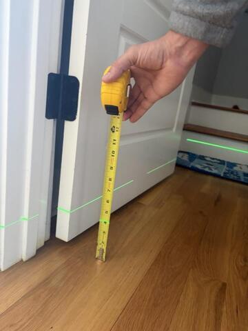 Inspecting the home with a laser level.