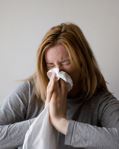 Woman sneezing