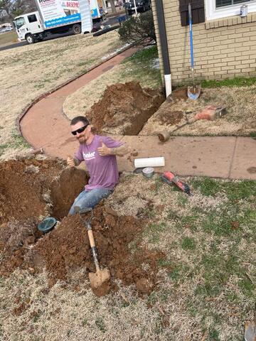 Frontier crew member lengthening a downspout.