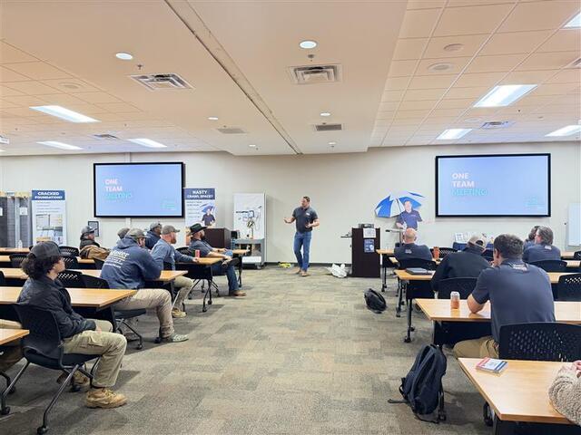 Dustin, our general manager, addressing our company at the One Team Meeting.