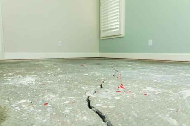 This indoor concrete floor has cracked as a result of pressure and conditions