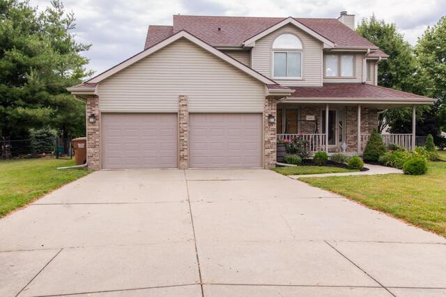 unlevel concrete driveway before repair in front of home