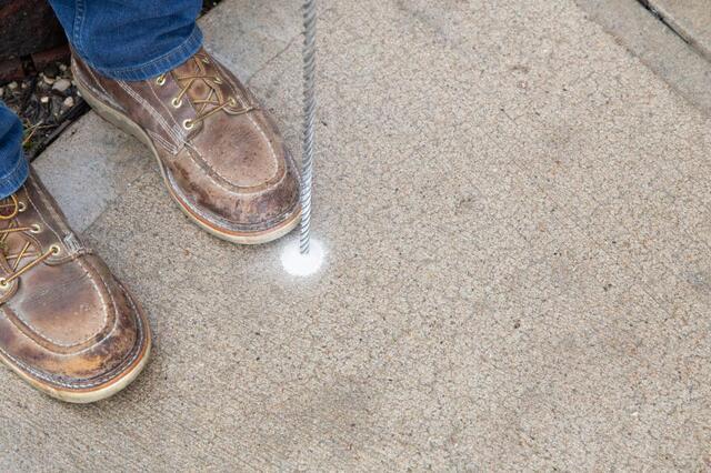Foreman Drilling into concrete slab