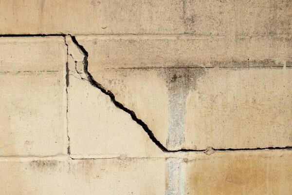 A wide stair-step crack with water staining underneath. Water coming through a crack like this means it's time for a professional inspection.
