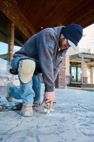 Mike injects PolyLevel Foam beneath the concrete to lift and level the concrete slab