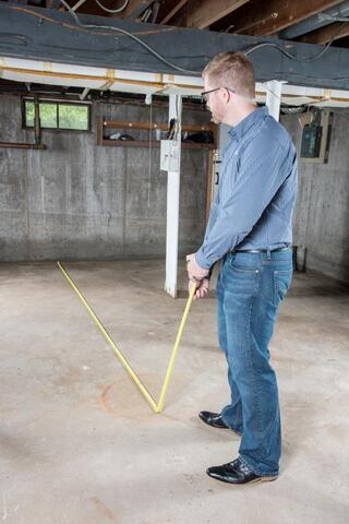 man measuring basement