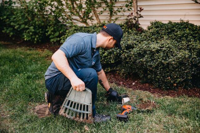 man checking external pipe