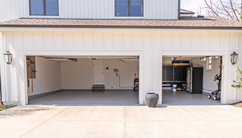 renovated three car garage with new cabinets and floor coating