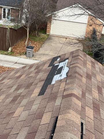 Garage door impact marks and surface damage commonly associated with hail storms documented during a McKinney roof and exterior inspection.