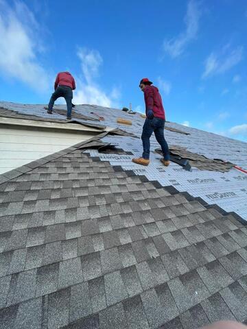 Roofing crew installing synthetic underlayment and preparing residential roof deck for new shingle installation in Allen, Texas.
