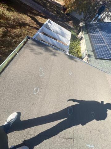 Flat roofing system inspection showing marked hail damage areas identified during storm damage evaluation in Allen, Texas.