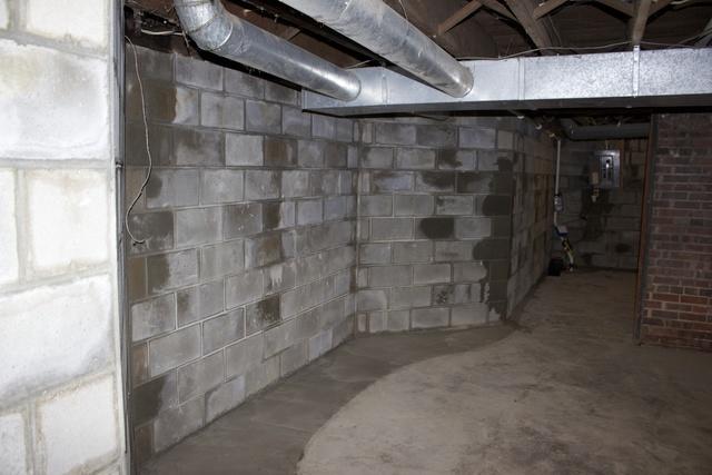 Completed foundation wall replacement with new block wall, some of the mortar joints are still drying.