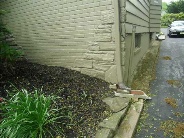 Standard gutters let water runoff too close to the home's foundation, sometimes causing leaks.