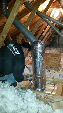 The furnace flue pipe is wrapped with rock wool insulation to keep it away from the other insulation. Rock wool is fire resistant.