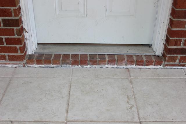 After- Concrete porch lifted and gap closed.