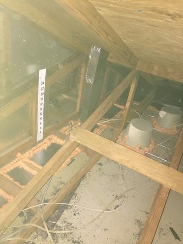 Here is that open bulkhead allowing cold air from the attic into the cabinets.  We sealed it off using 2" thick SilverGlo foam boards and one part orange foam. Notice the can lights also allowing cold air into the kitchen below.