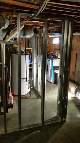 Framing in what will be the utility room - this will separate the apartment from the equipment in the basement. Having the hot water tank out of sight will really help to keep the space feeling clean and clutter free.