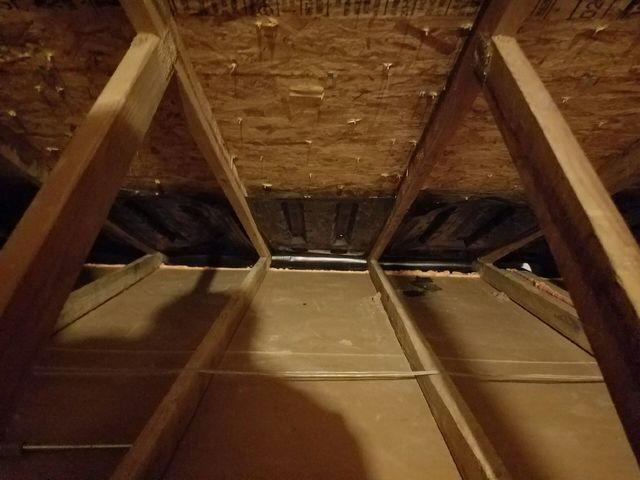 The existing attic insulation was removed and the attic floor was air sealed using one part spray foam. Notice the new soffit air baffles to make sure the attic ventilates properly with the new insulation in place.