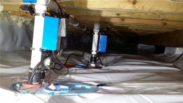 Two UltraSump sump pumps discharge water outside to keep the basement dry.