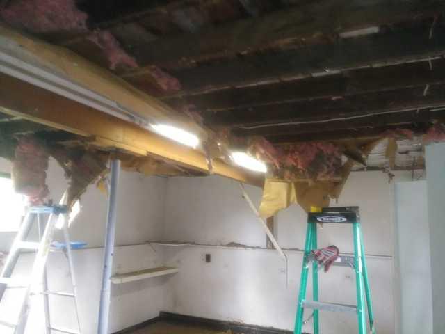 Tearing down old insulation.