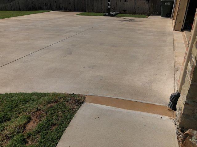 Driveway after PolyLevel and buried drain connected to the gutter