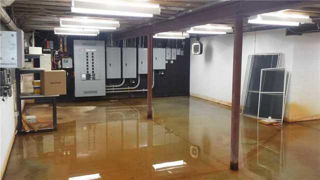 Not only did the basement have water, but the black plywood in the background was also soaked with moisture.