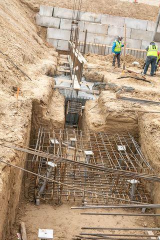 Exterior Constructions ite showing footing dug out, drilled with Helical Piers and filled with concrete for a sturdy foundation