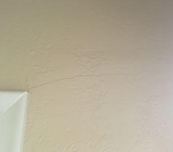 There were more cracks on the wall right by the door.