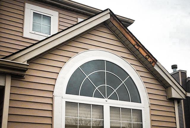 Fascia damage and exposed wood.