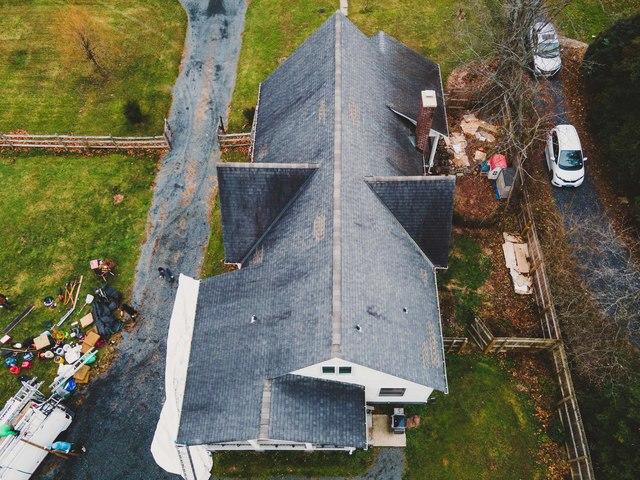 The old roof was covered in dark water streaks.
