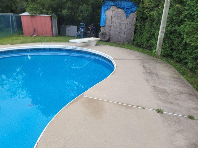 Before: The slanting of the concrete slabs around the pool deck.