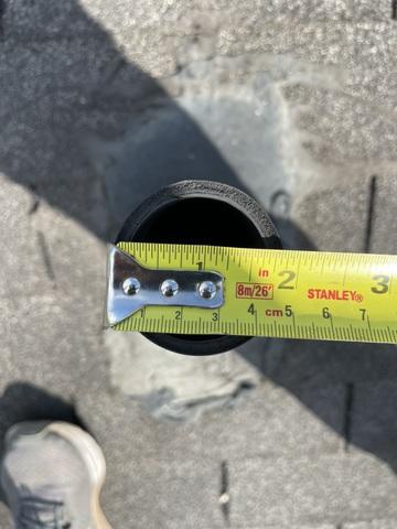 Excessive sealant around roof pipe.