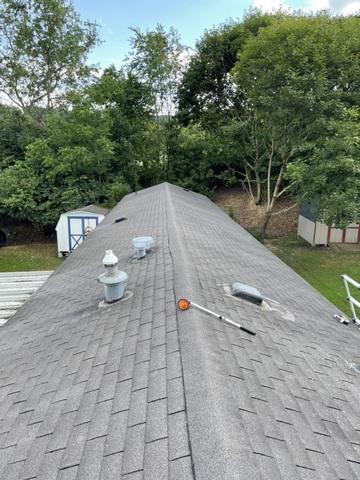 Shingled roof showing signs of age.