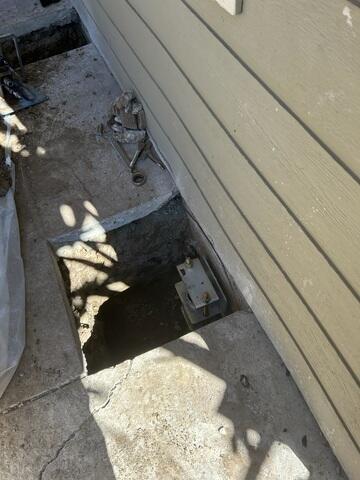 Progress image showing a pair of push piers installed and waiting for backfill.