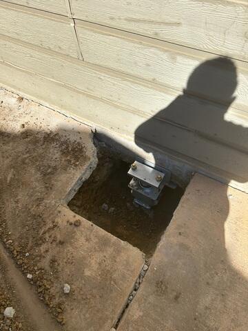 Additional image of an installed push pier awaiting backfill and concrete repair.
