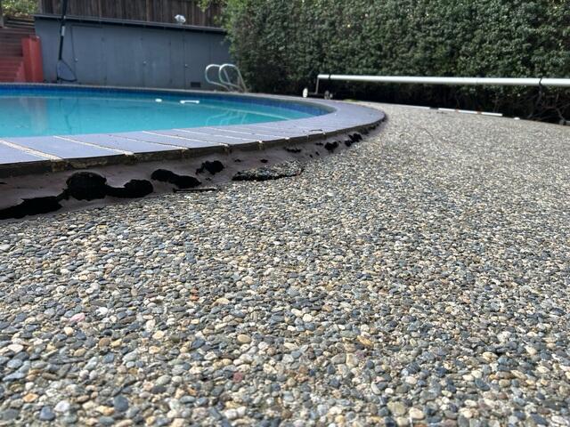 An additional before image of the sinking pool deck and uneven surface.