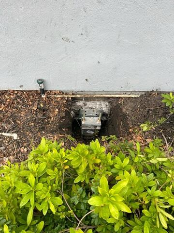 Progress image showing another installed push pier waiting for lift procedures and backfill.