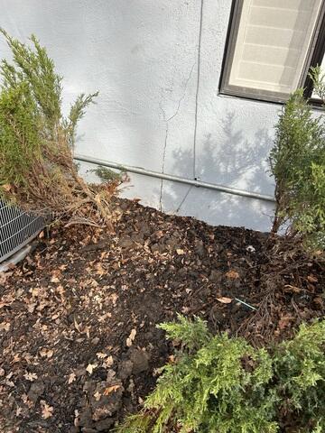 Before image showing cracking in the exterior stucco wall of the home.