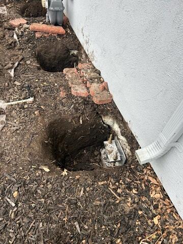 Progress image showing and installed pier awaiting the hydraulic lift procedure and backfill.