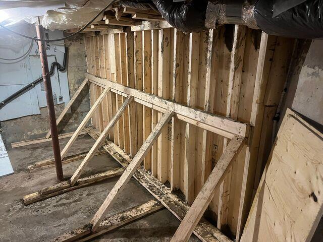 Preparing the existing wall to receive concrete.