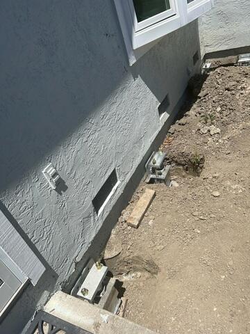 Progress image showing some additional push piers that have been installed prior to being completely backfilled and hidden.